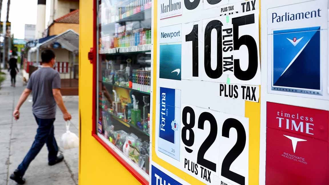 Outside a store, cigarette-pack images with prices: NEWPORT 10 with PLUS TAX sideways where the decimal would go, then a 5