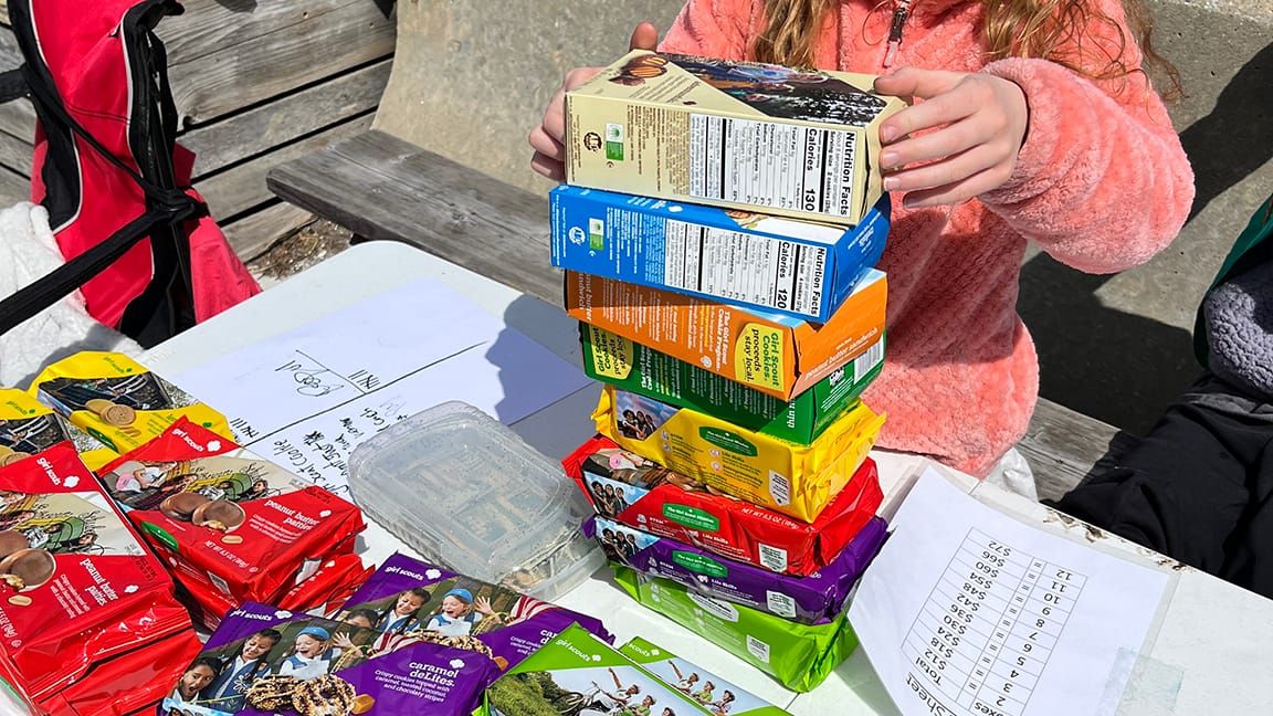 A Scout stacking up our cookie buy 