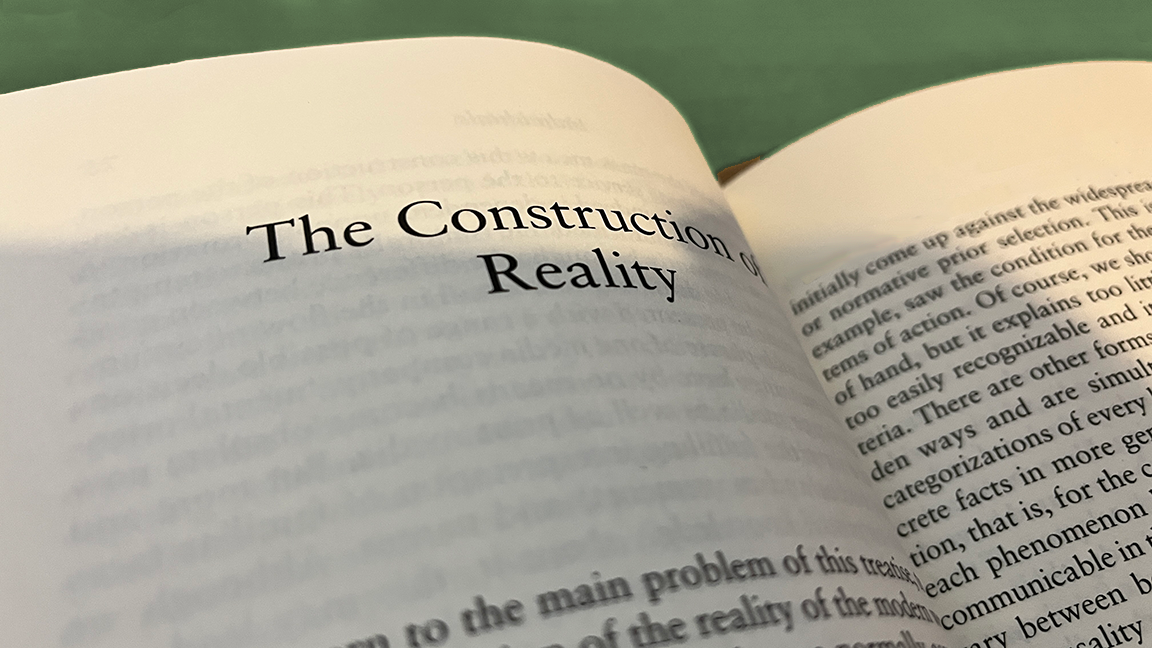 Photo of pages of the "Atlas of Realities" visible text: "The Construction of Reality... normative prior selection... 