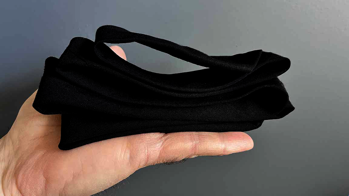 A hand holding a piled-up necktie