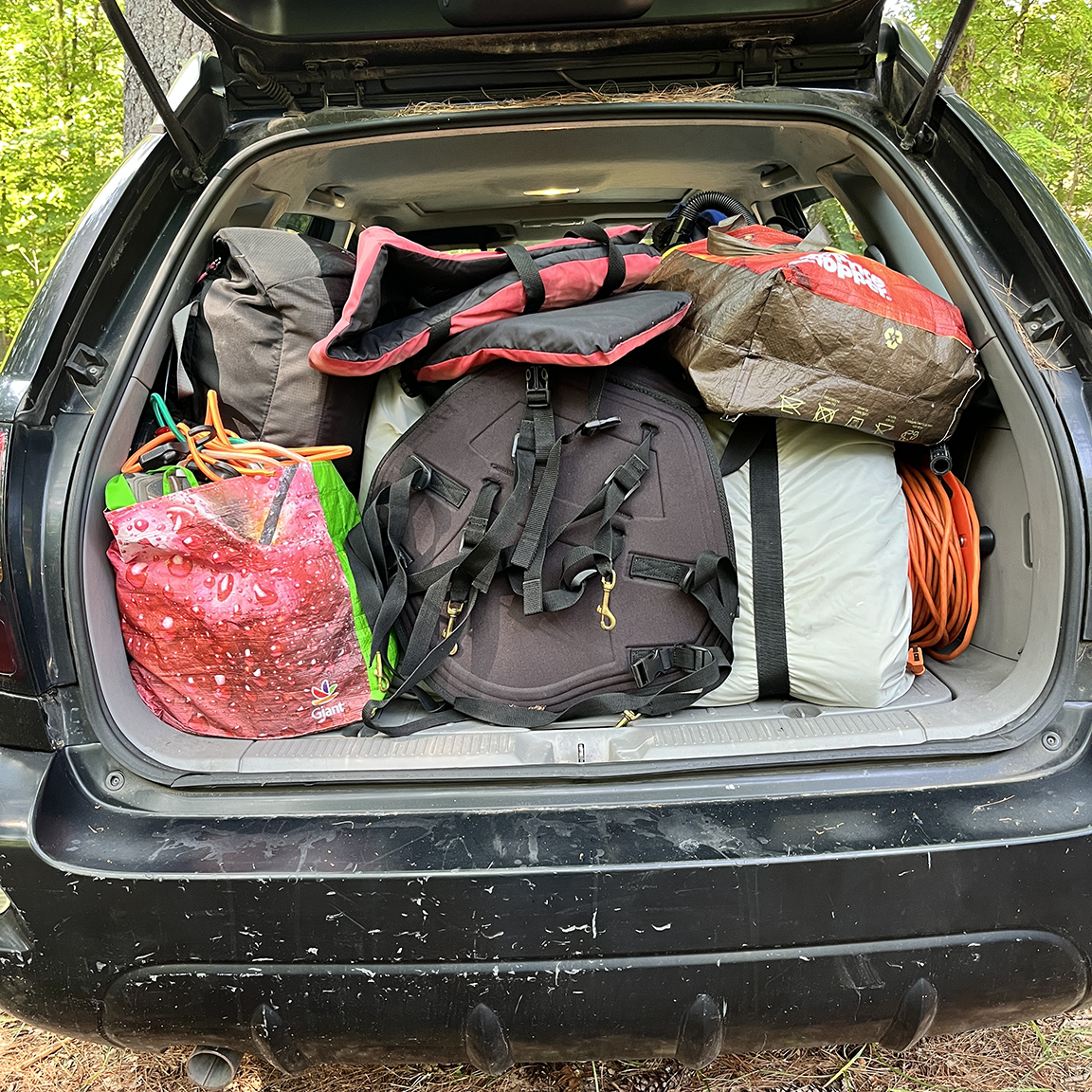 Rear hatch view, kayak seats, electrical extension cord, personal floatation devices, bags fulla too much stuff