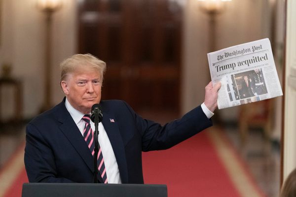 President Donald J. Trump, Feb. 6, 2020 East Room of White House, holding Washington Post with headline "Trump acquitted."