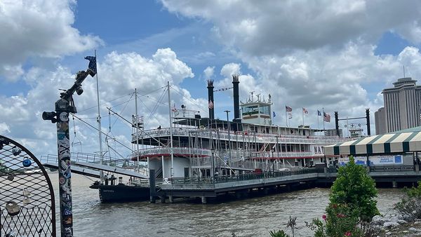 An old-timey riverboat docked on the Mississippi