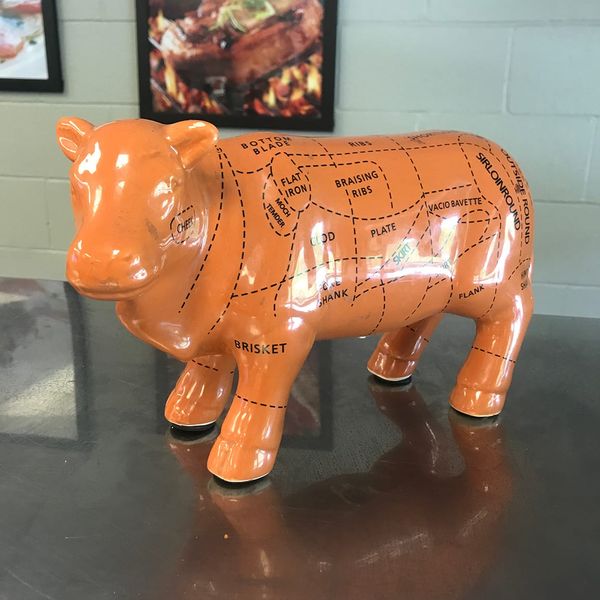 A little cow homunculus (vaca-munculus?) w/cuts diagram. BOTTOM BLADE - FLAT IRON - MOCH TEMDER - BRISKET - BRAISING RIBS - VACIO BAVETTE - FLANK - OUTSIDE ROUND - SKIRT - RIBS   