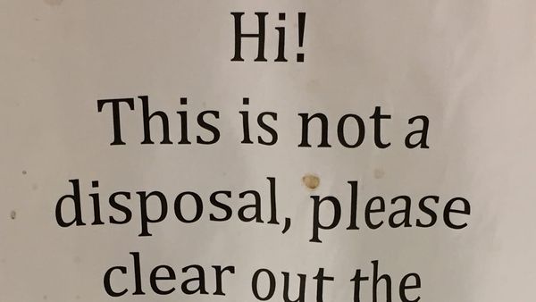 Fragment of a grimy, spattered office breakroom sign: HI! THIS IS NOT A DISPOSAL, PLEASE CLEAR OUT THE...