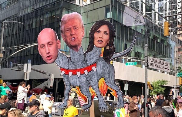 Protest-placard Cerberus with heads of Miller, Trump, and Noem.