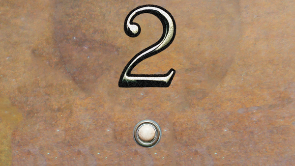 a little round button in the wall by the doorframe, and above it a brass numeral 2