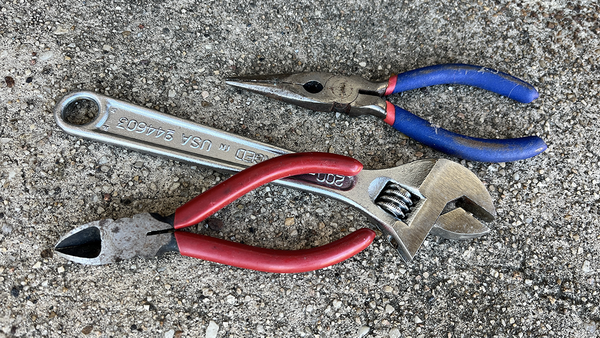 A pair of wire cutters, needlenose pliers and a wrench.