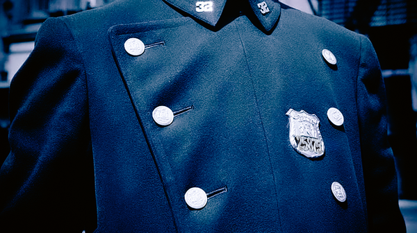 Bright buttons and badge on a heavy police uniform coat