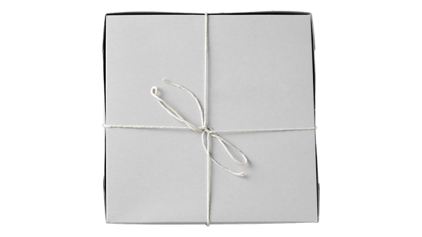 A white paperboard box secure with string