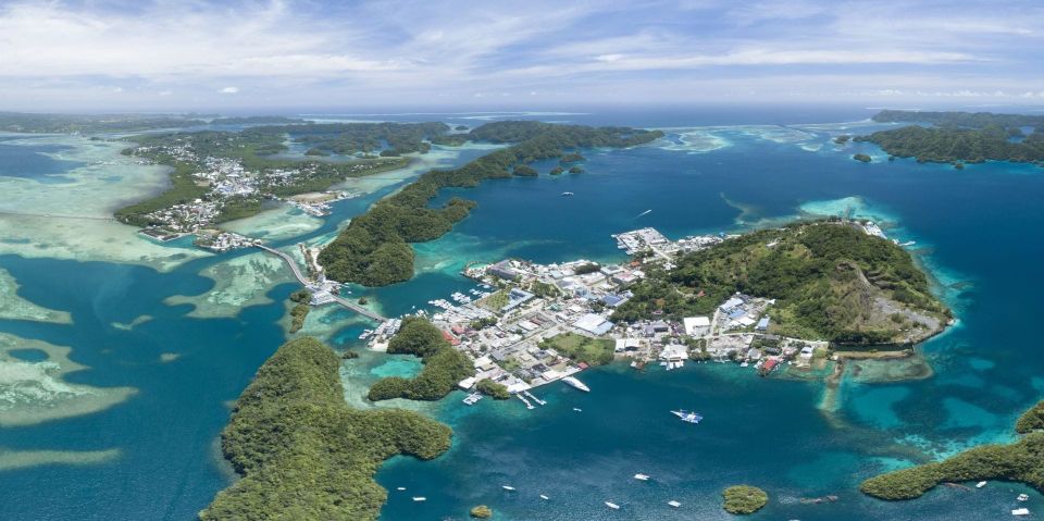 aerial photo of ocean, islands and housing area in Palau