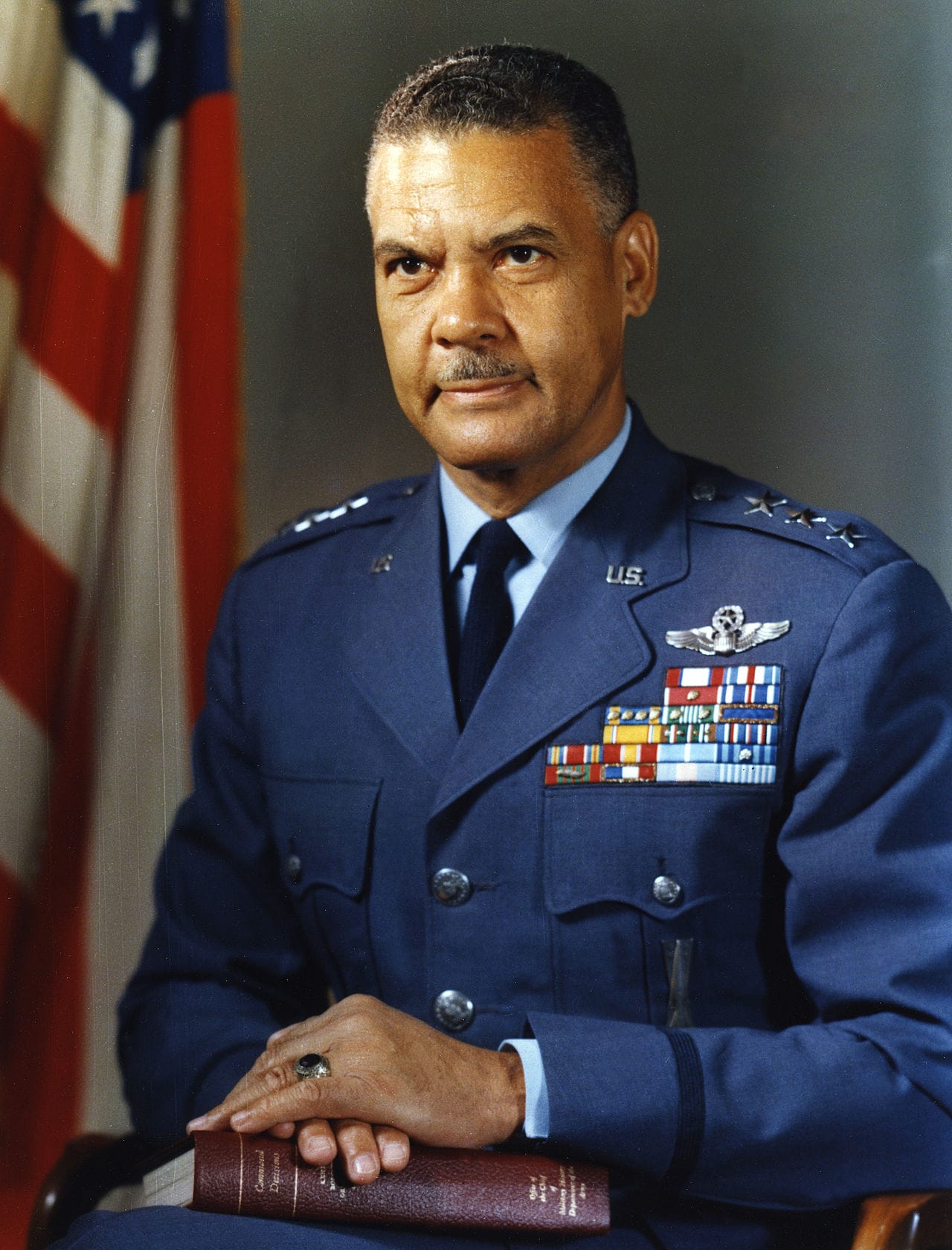 a portrait of then three star general Benjamin O Davis Jr in his formal military uniform