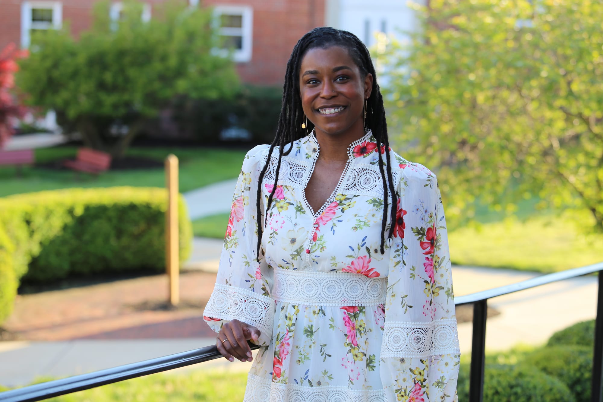 Alleanna Harris stands in front of the Moorestown Friends School campus.