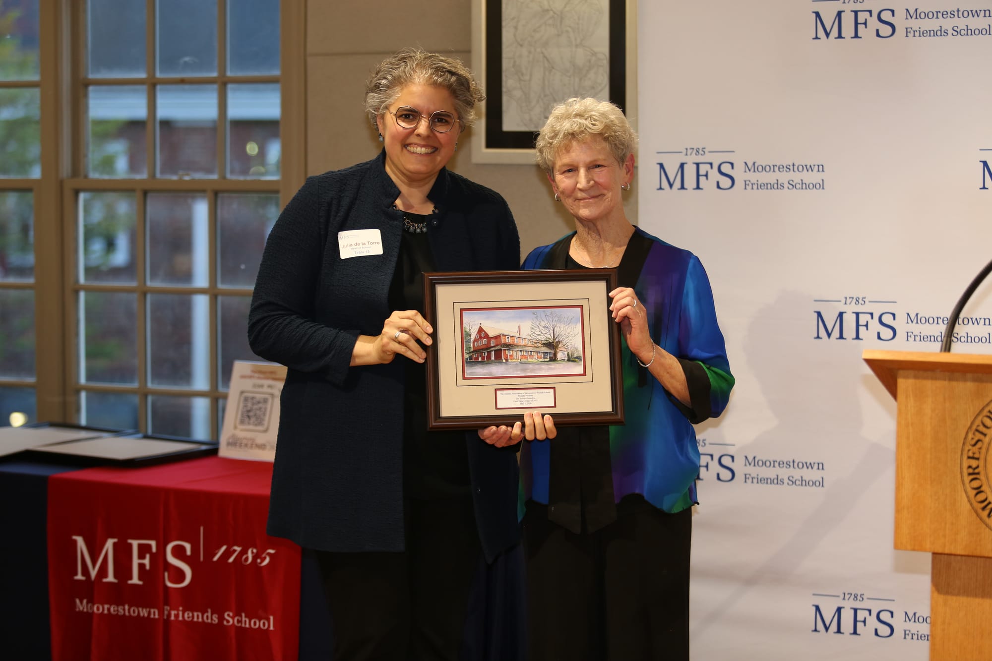 Carol Henry receiving the Service Award from Julia de la Torre, MFS Head of School.
