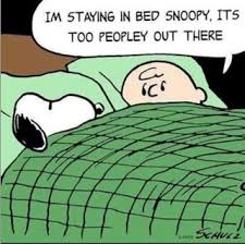 Charlie Brown and Snoopy under the covers. Charlie Brown says, "I'm staying in bed, Snoopy. It's too peopley out there."