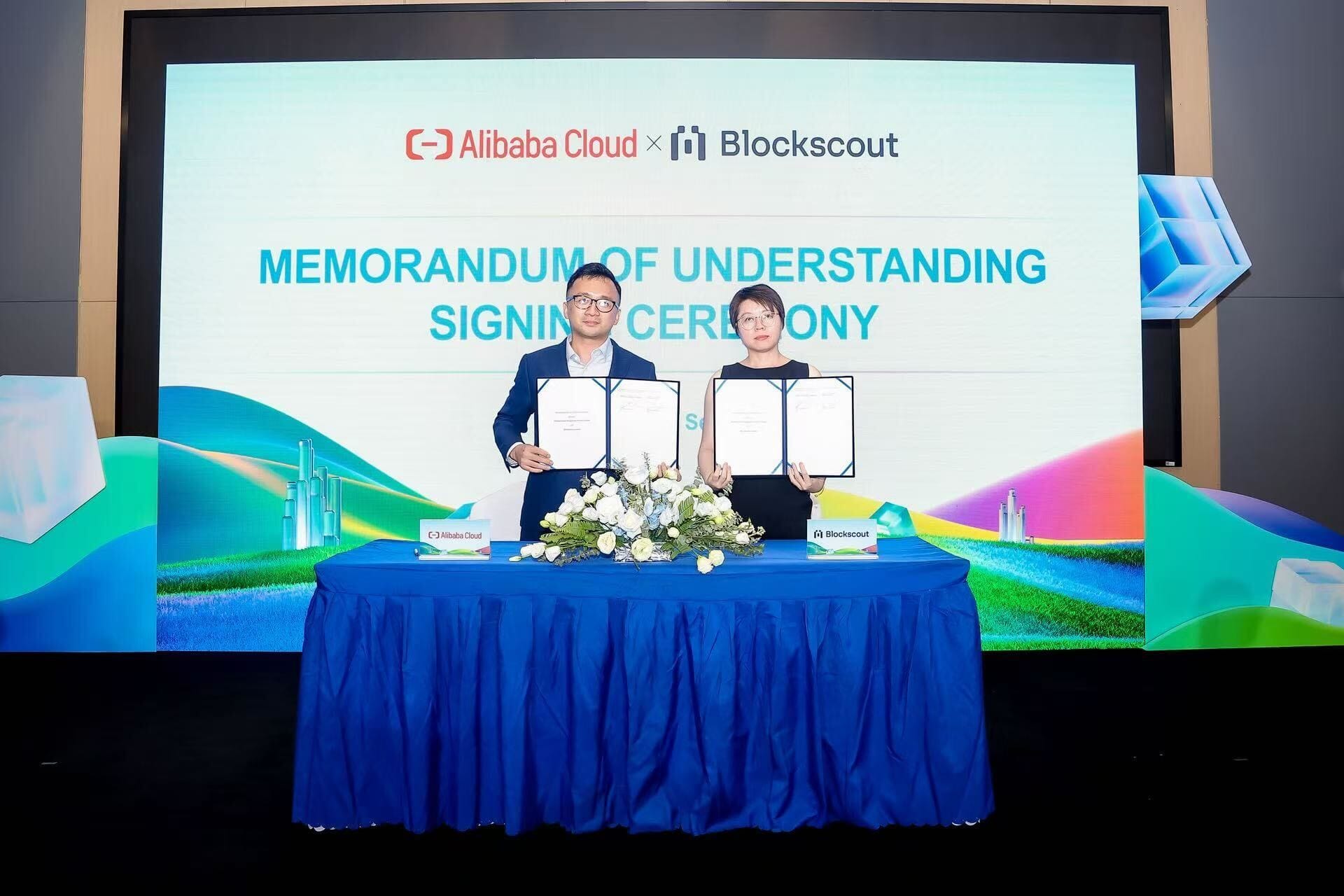 Alibaba Cloud and Blockscout partnership MOU signing ceremony with executives holding signed agreement
