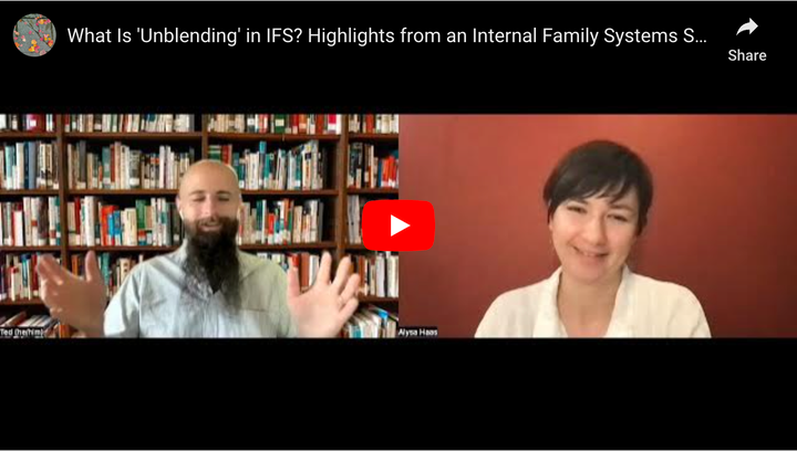 Still from the YouTube video linked below, showing a bald white man with a brown beard and a white woman with brown hair.