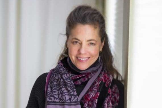 Photo of Robyn Lending Halsten, a white woman with long brown hair, smiling to the camera.