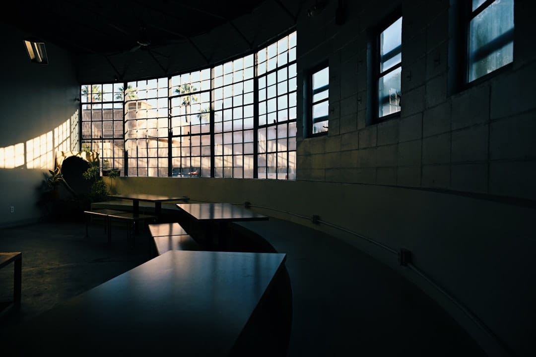 Sunlight streams through large windows in a modern cafe.