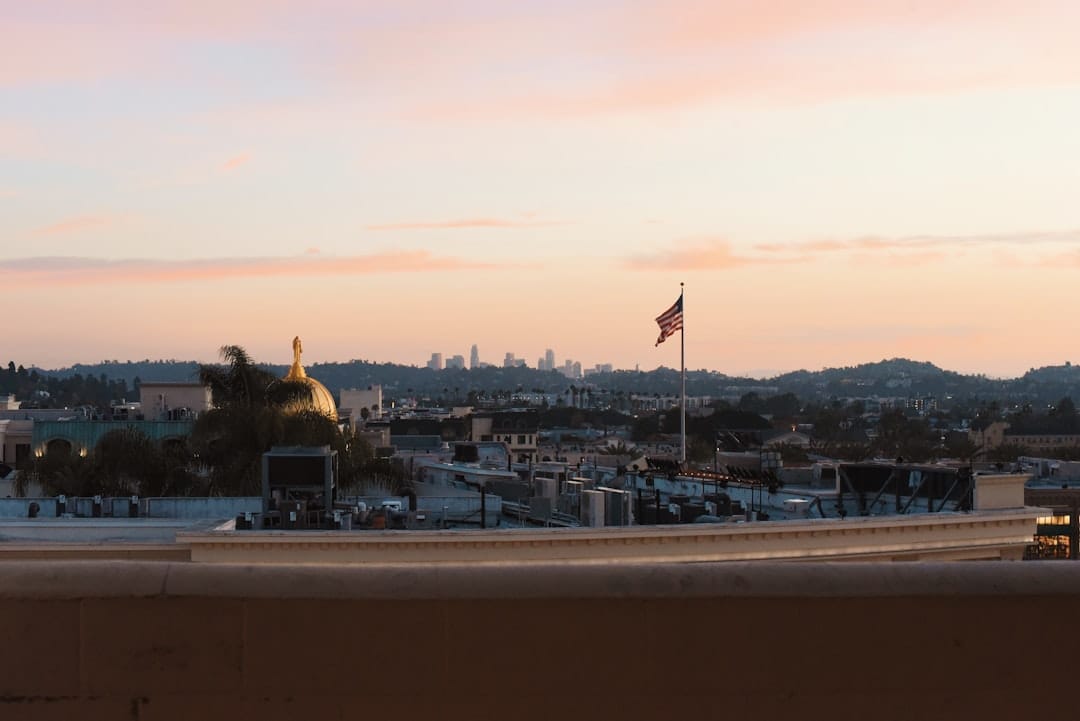 City skyline with american flag at sunset.
