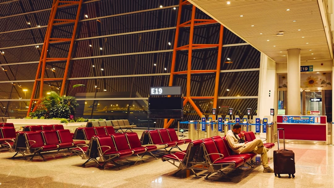 Man sitting in empty airport waiting area