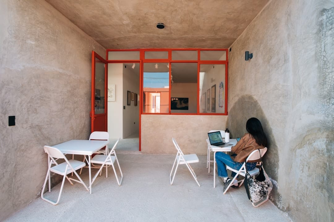 Woman working on laptop in a minimalist room