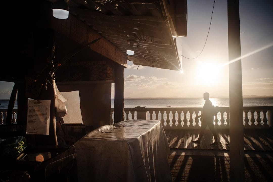 Silhouette of a person on a balcony at sunset