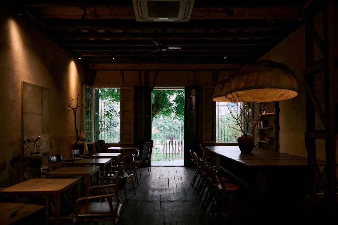 Dimly lit cafe interior with tables and chairs.