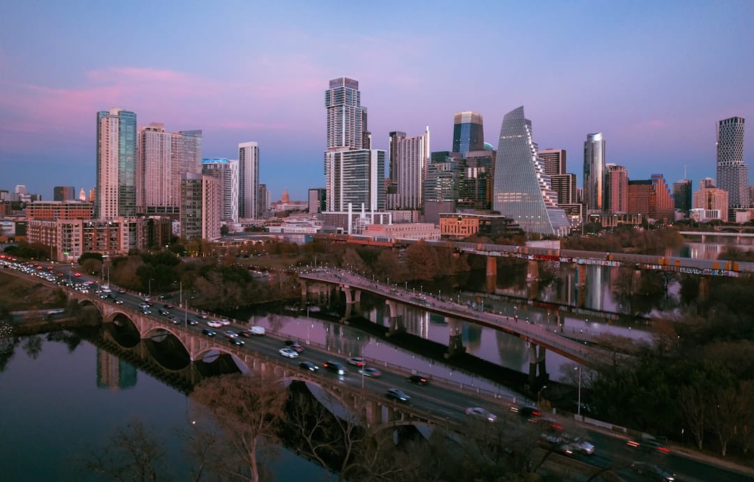 City skyline with bridges and river at dusk