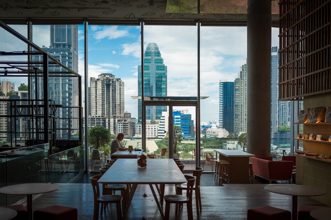 Modern cafe interior with city view through windows