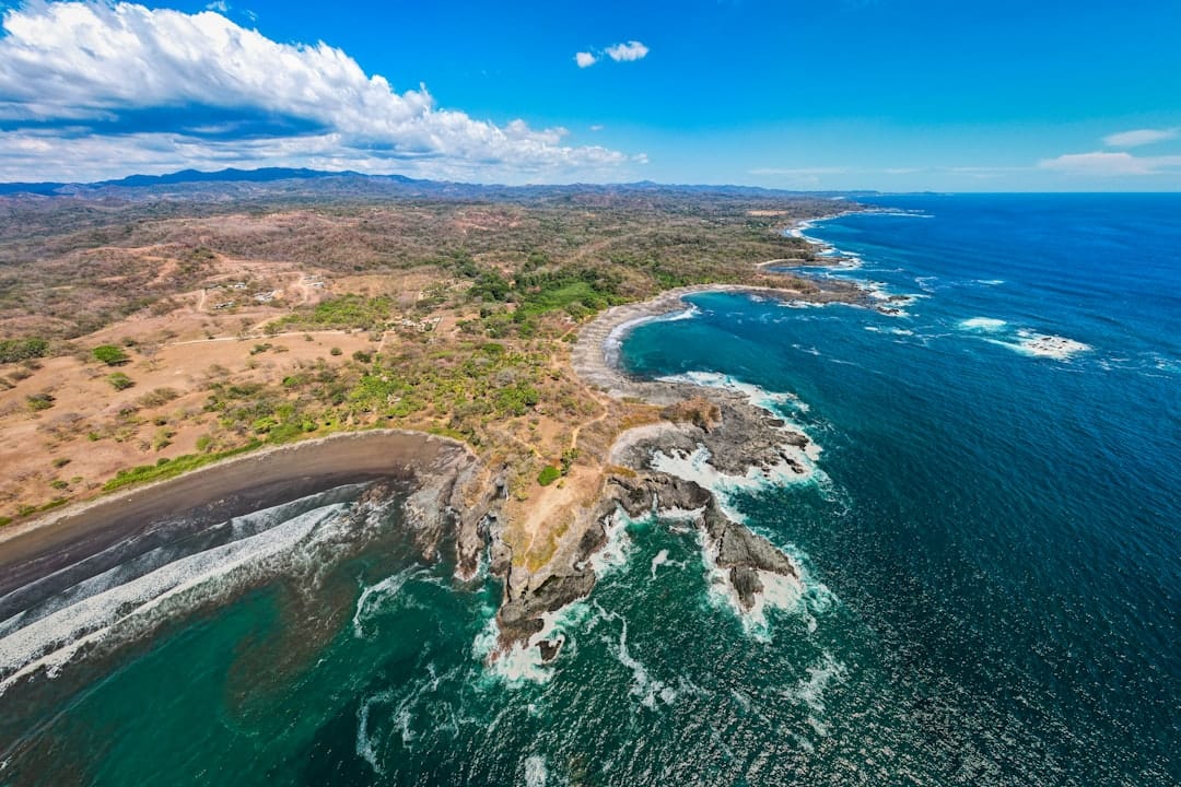 an aerial view of the coastline of a tropical island