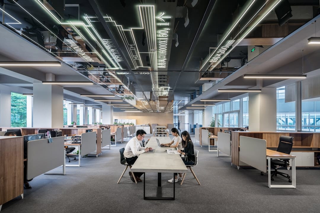 three people collaborating in open office