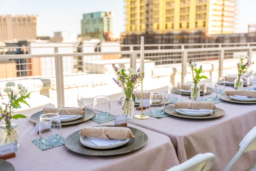 Rooftop dinner table is set, ready for guests.