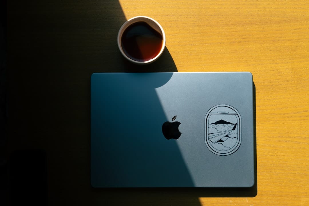 a laptop computer sitting on top of a wooden table