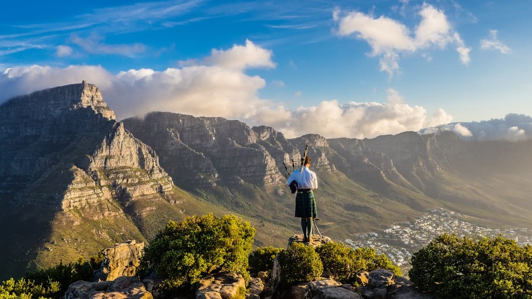 person standing on cliff during daytime