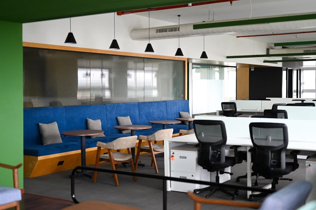 Modern office space with blue seating and desks