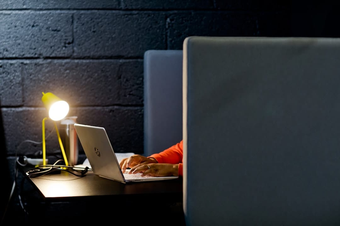 a person working on a laptop in a dark room