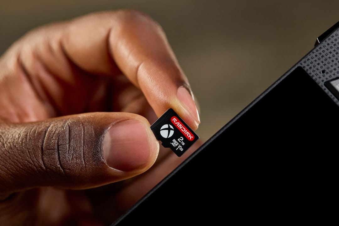Hand inserting an xbox microsd card into a device
