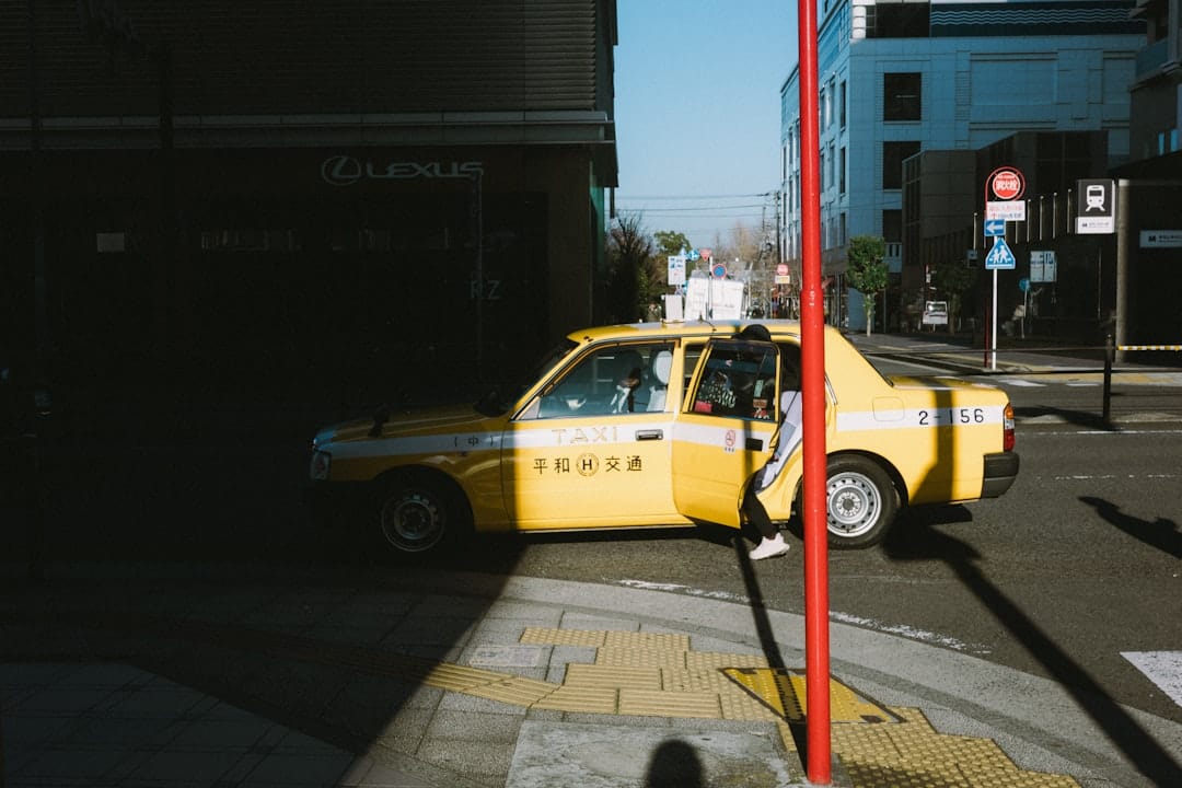 Yellow taxi with open door on a city street