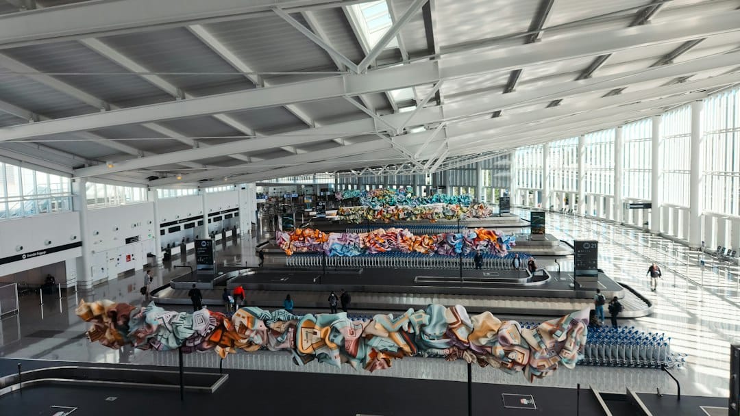 An airport terminal with lots of luggage on the conveyor belt