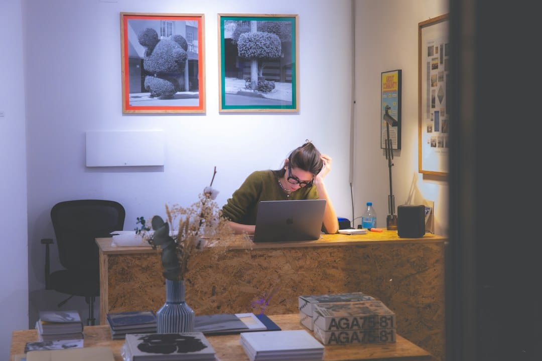 A man sitting at a desk working on a laptop