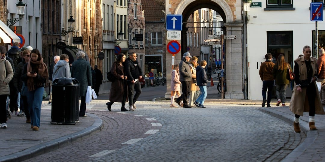 People walking on a cobblestone street in a european city