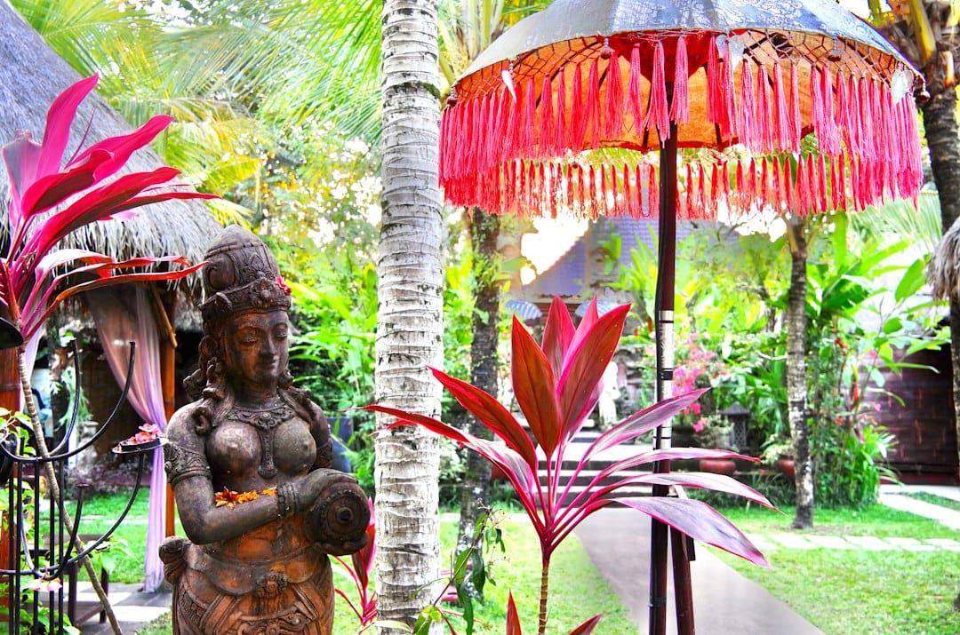 a statue of a woman holding a baby in a garden