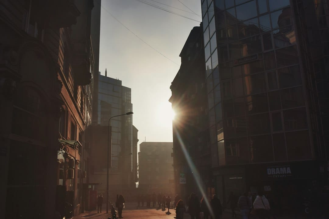 people walking on street between high rise buildings during daytime
