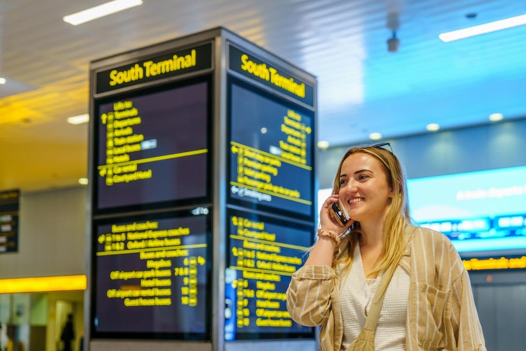 Woman talking on phone near south terminal departure board
