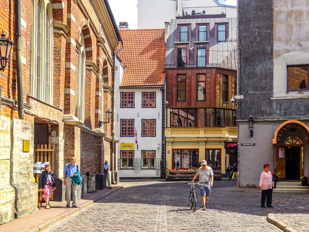 People walking on cobblestone street in old european city