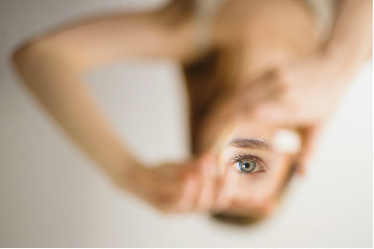 Creative abstract photography of a woman's eye with shallow depth of field and an upside-down perspective.