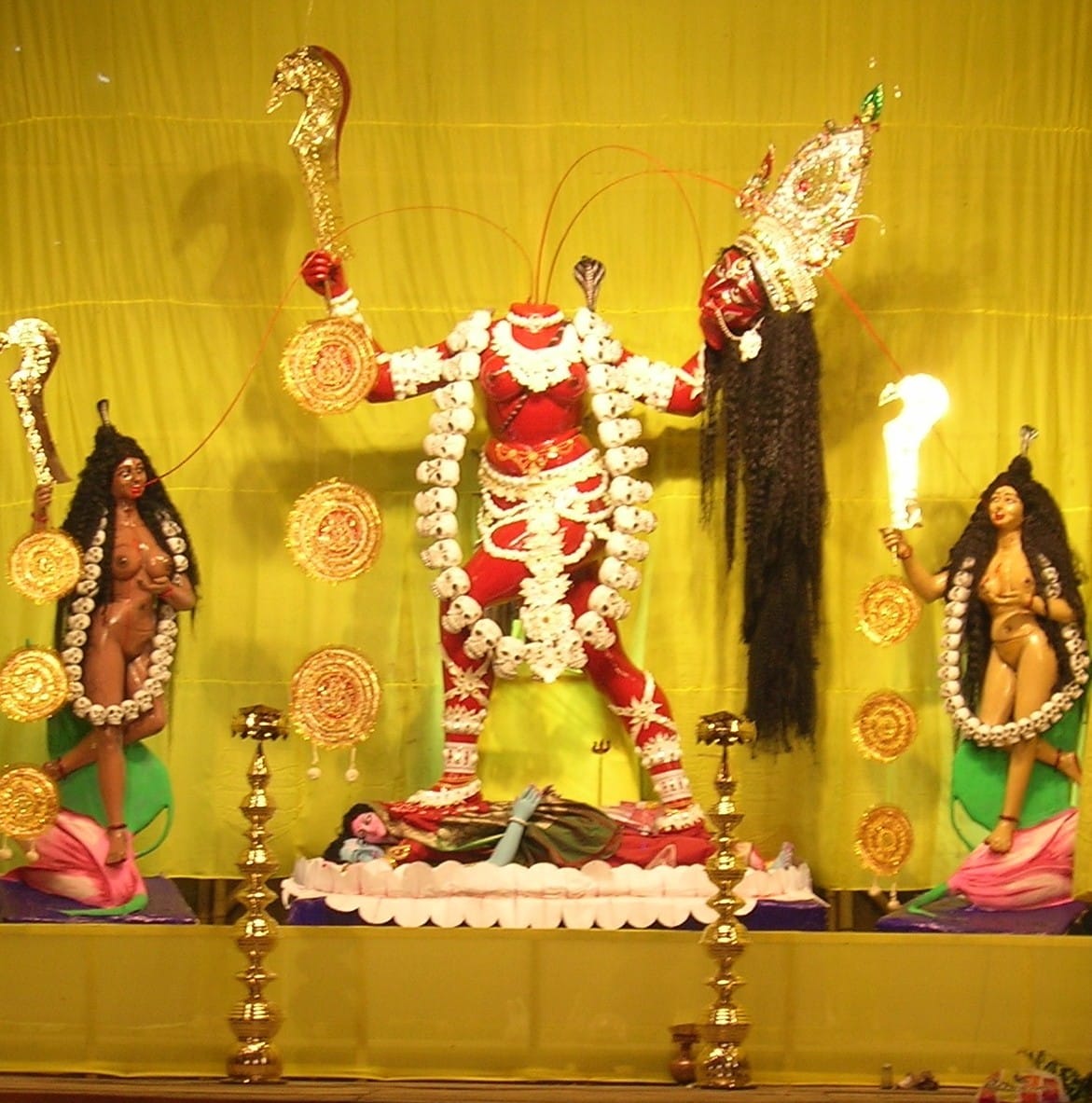 Chhinnamastā idol at a Kali Puja pandal in Kolkata, depicting the fierce Mahāvidyā goddess holding her severed head with blood streams feeding her attendants.