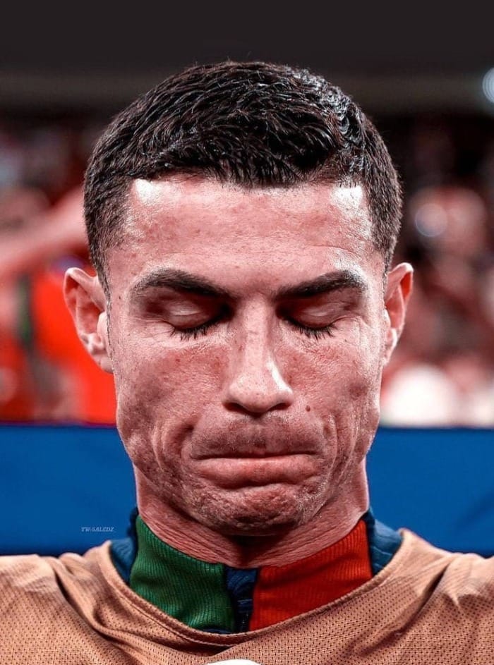 Cristiano Ronaldo in a moment of intense pre-match focus, eyes closed, embodying discipline and inevitability before competition