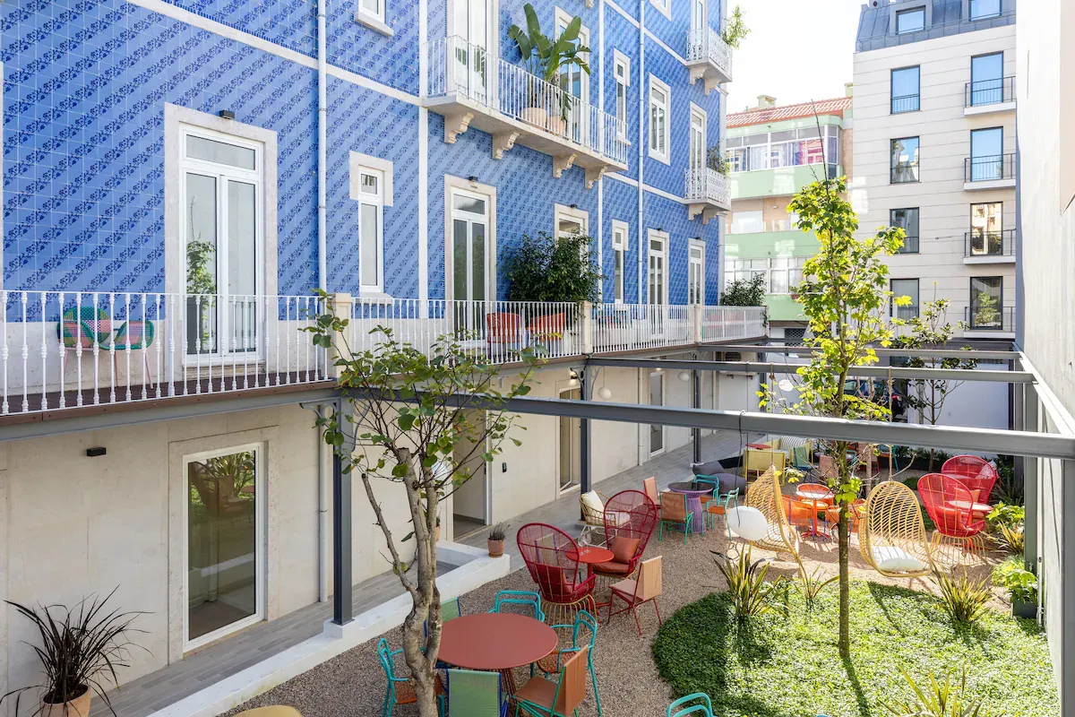 Haws Lisboa boutique courtyard with colorful design — a minimalist calm space ideal for deep manifestation work and identity shifts.